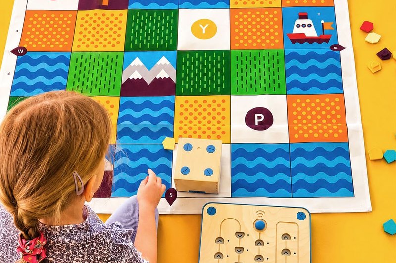 Robot bees on a mat of colours and shapes